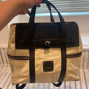 Henri Bendel nylon crème and black backpack. Needs to be professionally cleaned.